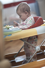 Image showing baby learning to walk in walker