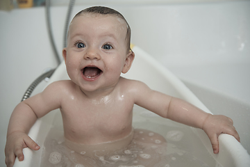 Image showing cute little baby girl taking a bath