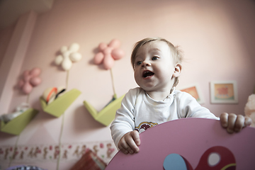 Image showing cute little one year old baby and making first steps