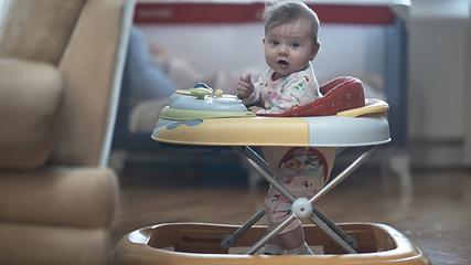 Image showing baby learning to walk in walker