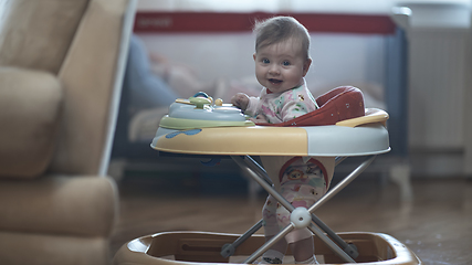 Image showing baby learning to walk in walker