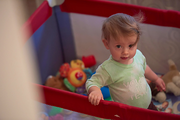 Image showing cute little baby playing in mobile bed