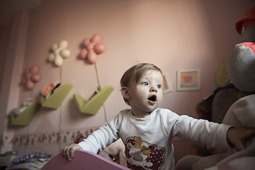 Image showing cute little one year old baby and making first steps