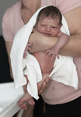 Image showing Grandmother is bathing Newborn baby girl