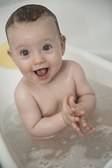 Image showing cute little baby girl taking a bath