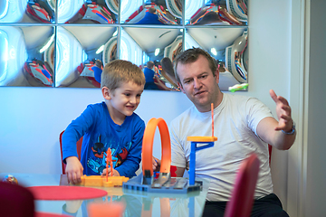 Image showing Father and children playing car toy game