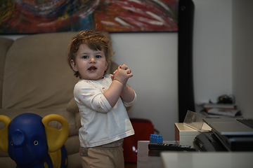 Image showing Adorable cute beautiful little baby girl playing with toys at home