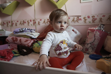 Image showing cute little one year old baby and making first steps