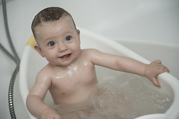 Image showing cute little baby girl taking a bath