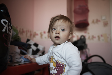 Image showing cute little one year old baby and making first steps