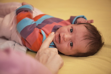 Image showing One month newborn baby sleeping in bed