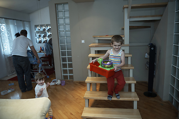 Image showing Little child playing and bring toys to sister