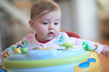 Image showing baby learning to walk in walker