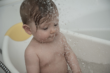 Image showing cute little baby girl taking a bath