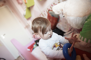 Image showing cute little one year old baby and making first steps