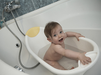 Image showing cute little baby girl taking a bath