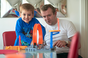 Image showing Father and children playing car toy game