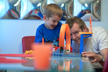 Image showing Father and children playing car toy game