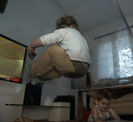 Image showing Little child playing with sister at home