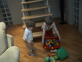 Image showing Little child playing and bring toys to sister