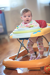 Image showing baby learning to walk in walker