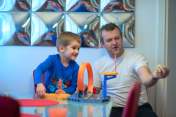 Image showing Father and children playing car toy game