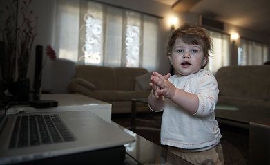 Image showing Adorable cute beautiful little baby girl playing with toys at home