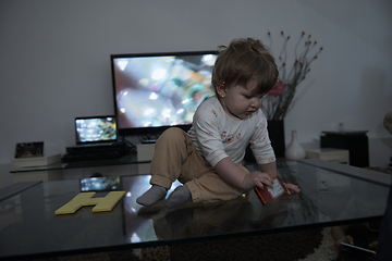 Image showing cute little one year old baby and making first steps