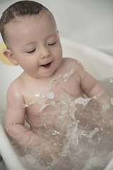 Image showing cute little baby girl taking a bath