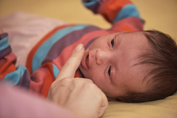 Image showing One month newborn baby sleeping in bed