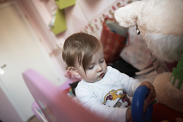 Image showing cute little one year old baby and making first steps