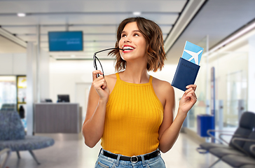 Image showing happy young woman with air ticket at airport