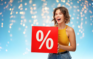 Image showing smiling young woman with sale sign over lights