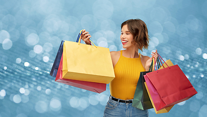 Image showing happy smiling young woman with shopping bags