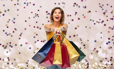 Image showing happy smiling young woman with shopping bags