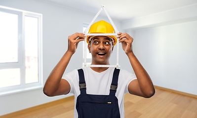 Image showing happy indian builder with ruler in shape of home