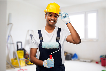 Image showing happy indian painter or builder with paint roller