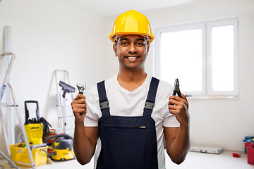 Image showing indian builder in helmet with wrench and pliers