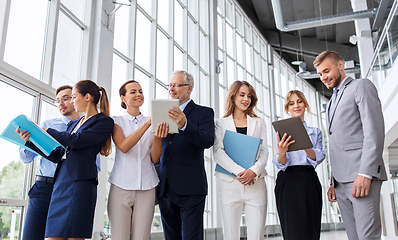 Image showing business team with tablet pc and folders at office