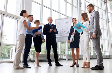 Image showing business team with scheme on flip chart at office