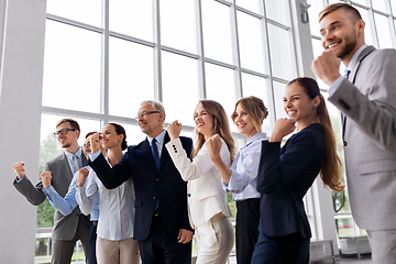 Image showing happy business team celebrating success at office