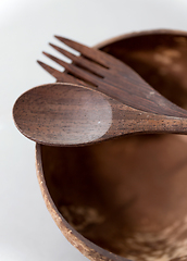 Image showing close up of coconut bowl, wooden spoon and fork