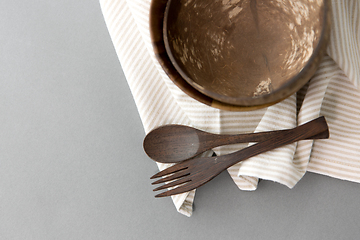 Image showing close up of coconut bowl, wooden spoon and fork