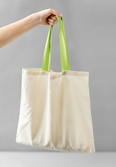 Image showing hand holding reusable canvas bag for food shopping