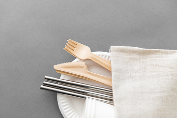 Image showing wooden forks, knives and paper cups on plate