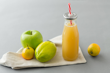 Image showing reusable glass bottle of fruit juice with straw