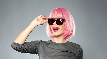 Image showing happy woman in pink wig and black sunglasses