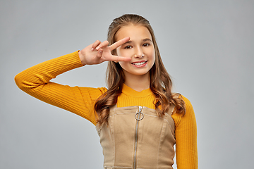 Image showing smiling young teenage girl showing peace hand sign