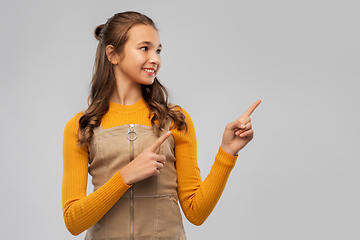 Image showing young teenage girl pointing fingers up