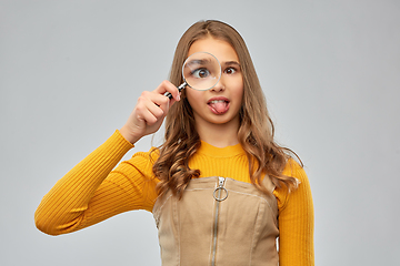 Image showing teenage girl looking through magnifying glass